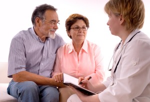 A senior couple speaking with a doctor
