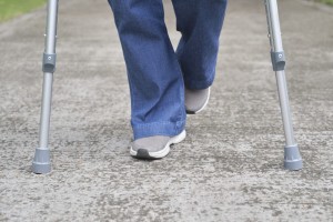 Picture of a person using crutches after fracture surgery.