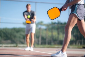 Picture of a man and a woman playing pickleball.